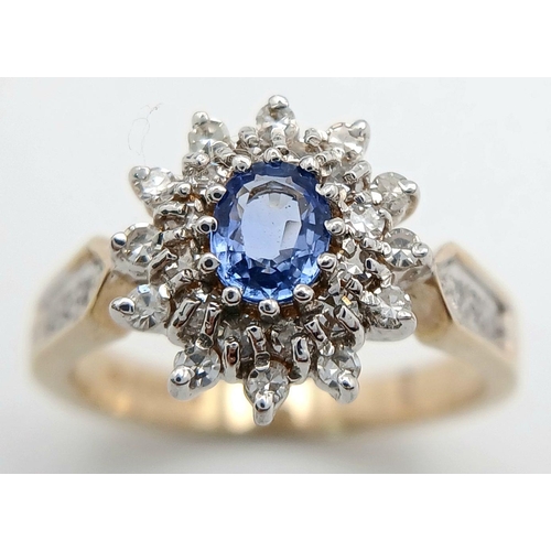 619 - A 9K YELLOW GOLD DIAMOND AND BLUE TOPAZ CLUSTER RING. 3.5G. SIZE M. GW7