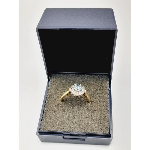 63 - An exceptionally pretty hallmarked 18 CARAT GOLD, AQUAMARINE and DIAMOND RING. Presented in ring box... 