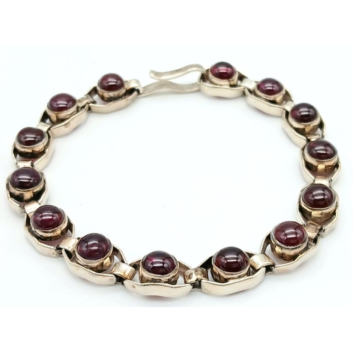 669 - A Vintage Sterling Silver Garnet Set Tennis Bracelet. 19.5cm Length. Set with 6mm Round Cut Garnet C... 