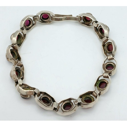 669 - A Vintage Sterling Silver Garnet Set Tennis Bracelet. 19.5cm Length. Set with 6mm Round Cut Garnet C... 