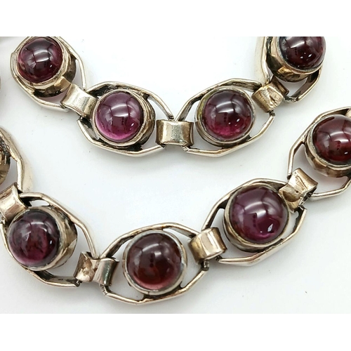 669 - A Vintage Sterling Silver Garnet Set Tennis Bracelet. 19.5cm Length. Set with 6mm Round Cut Garnet C... 