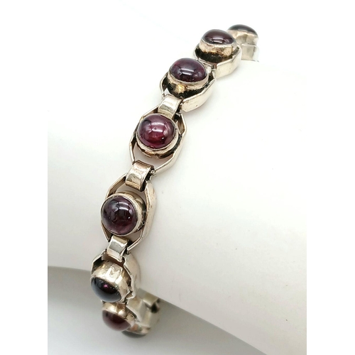 669 - A Vintage Sterling Silver Garnet Set Tennis Bracelet. 19.5cm Length. Set with 6mm Round Cut Garnet C... 