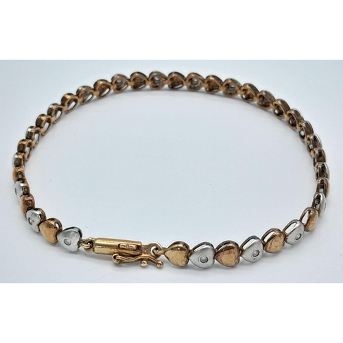 84 - An exquisite 9 carat GOLD TENNIS BRACELET. Consisting WHITE and BRONZE GOLD LINKS  in heart form, ea... 