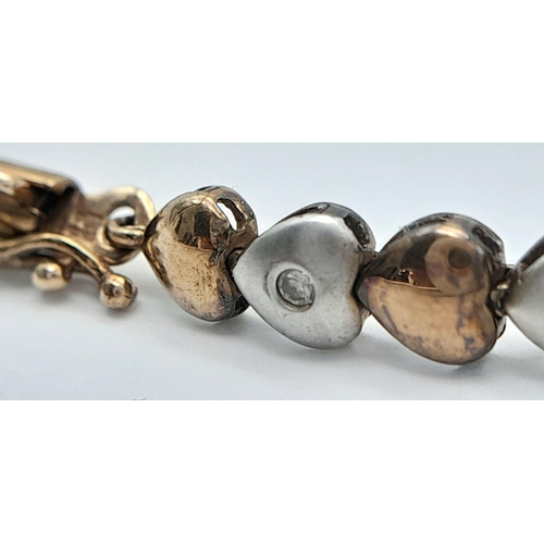 84 - An exquisite 9 carat GOLD TENNIS BRACELET. Consisting WHITE and BRONZE GOLD LINKS  in heart form, ea... 