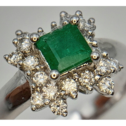 437 - AN 18K WHITE GOLD DIAMOND AND EMERALD CLUSTER RING. 0.38CTW DIAMONDS AND 0.52CT EMERALD. 4.5G. SIZE ... 