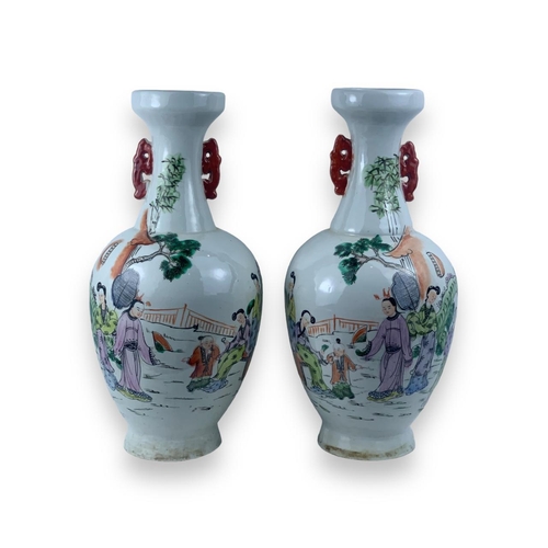 1355 - A Pair of antique Chinese Famille Rose Porcelain Vases. White porcelain exterior with multicolored h... 