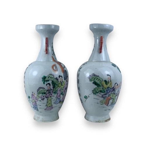 1355 - A Pair of antique Chinese Famille Rose Porcelain Vases. White porcelain exterior with multicolored h... 