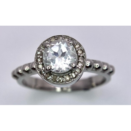 1745 - A Green Amethyst and Diamond Ring set in 925 Silver. Central round cut amethyst with a diamond halo.... 