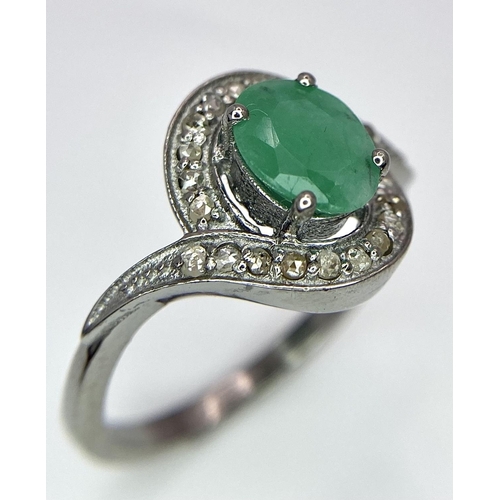 1656 - An Emerald Ring with a Rose Cut Diamond Surround. Set in 925 Sterling silver. Emerald - 0.70ct. Diam... 