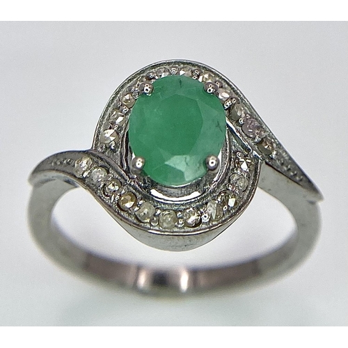 1656 - An Emerald Ring with a Rose Cut Diamond Surround. Set in 925 Sterling silver. Emerald - 0.70ct. Diam... 