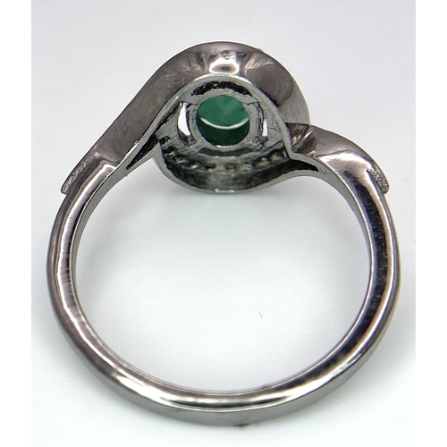 1656 - An Emerald Ring with a Rose Cut Diamond Surround. Set in 925 Sterling silver. Emerald - 0.70ct. Diam... 