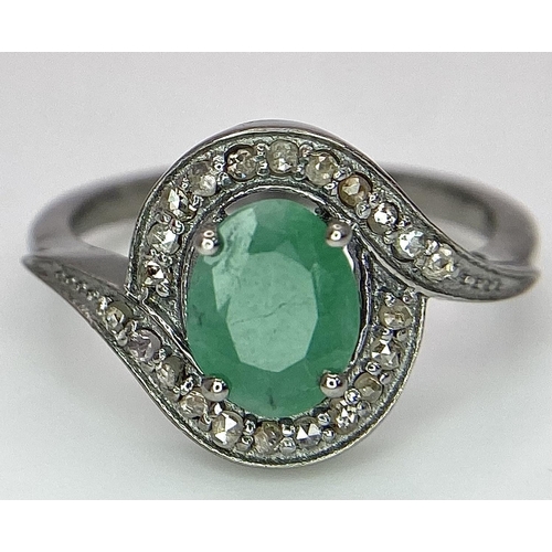 1656 - An Emerald Ring with a Rose Cut Diamond Surround. Set in 925 Sterling silver. Emerald - 0.70ct. Diam... 