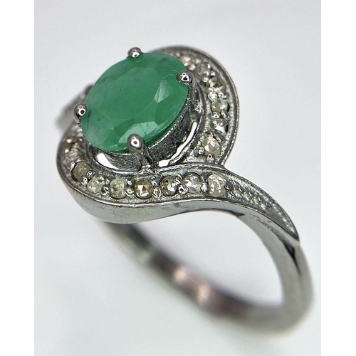 1656 - An Emerald Ring with a Rose Cut Diamond Surround. Set in 925 Sterling silver. Emerald - 0.70ct. Diam... 