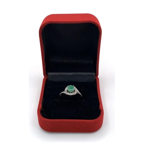 1656 - An Emerald Ring with a Rose Cut Diamond Surround. Set in 925 Sterling silver. Emerald - 0.70ct. Diam... 