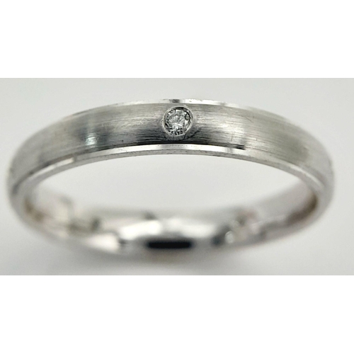 221 - AN 18K WHITE GOLD DIAMOND SET BAND RING - FROSTED CENTRE. 3.6G. SIZE O. A/S 1172