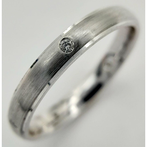 221 - AN 18K WHITE GOLD DIAMOND SET BAND RING - FROSTED CENTRE. 3.6G. SIZE O. A/S 1172