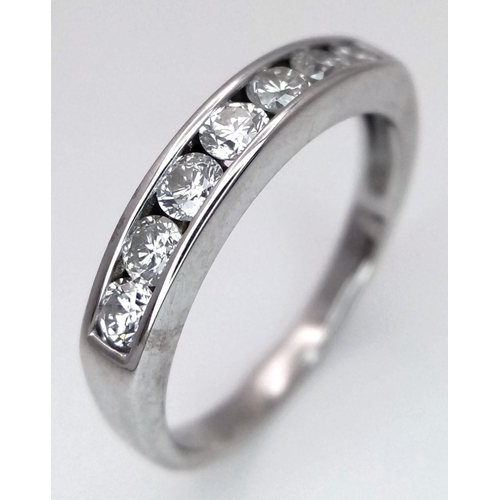 333 - AN 18K WHITE GOLD DIAMOND HALF ETERNITY RING - 0.35CTW. 3.1G. SIZE L.