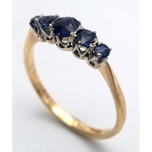 535 - AN 18K YELLOW GOLD SAPPHIRE SET FIVE STONE RING - 1.6G. SIZE N. TAN6022.