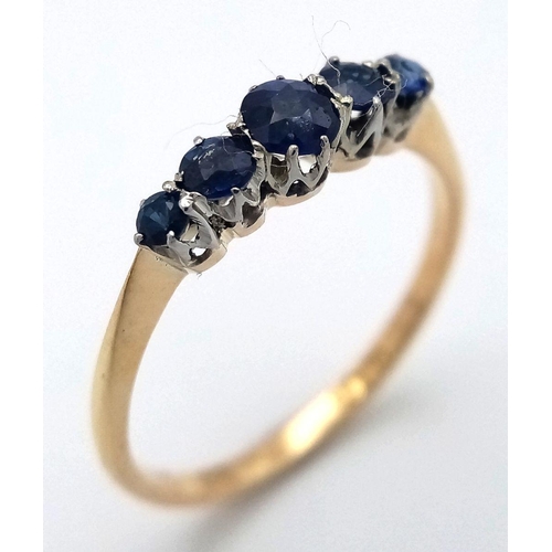 535 - AN 18K YELLOW GOLD SAPPHIRE SET FIVE STONE RING - 1.6G. SIZE N. TAN6022.