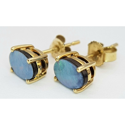 571 - A Pair of 10 Carat Yellow Gold Opal Set Stud Earrings; Set with 6mm Long Oval Cut Opals that have ex... 