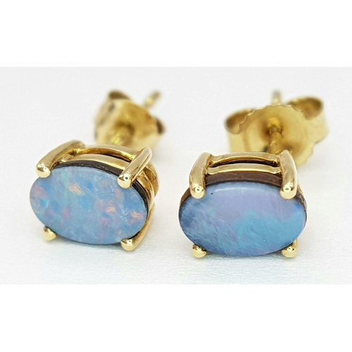 571 - A Pair of 10 Carat Yellow Gold Opal Set Stud Earrings; Set with 6mm Long Oval Cut Opals that have ex... 