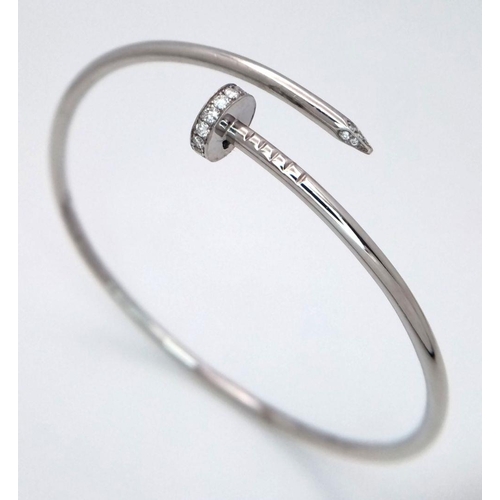 654 - An 18K White Gold Diamond Nail Design Bangle. 8.4g total weight. NL94204