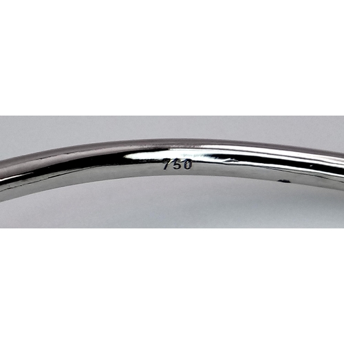 654 - An 18K White Gold Diamond Nail Design Bangle. 8.4g total weight. NL94204