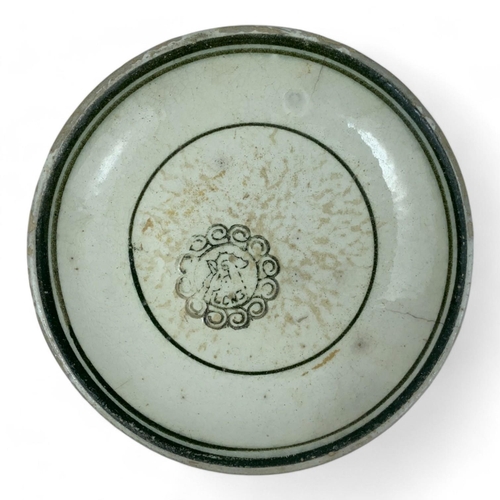 1341 - An antique set of Annam porcelain dishes with a circular motif. White and green glazed porcelain wit... 