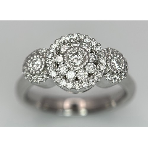 409 - A 14K WHITE GOLD TRIPLE DIAMOND CLUSTER RING - 0.65CTW. 6.4G. SIZE Q. TAN6013