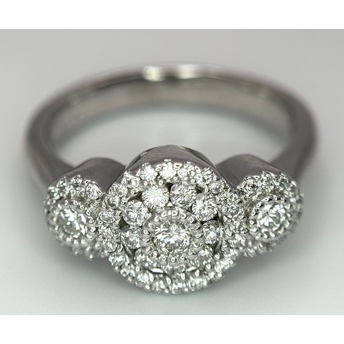 409 - A 14K WHITE GOLD TRIPLE DIAMOND CLUSTER RING - 0.65CTW. 6.4G. SIZE Q. TAN6013