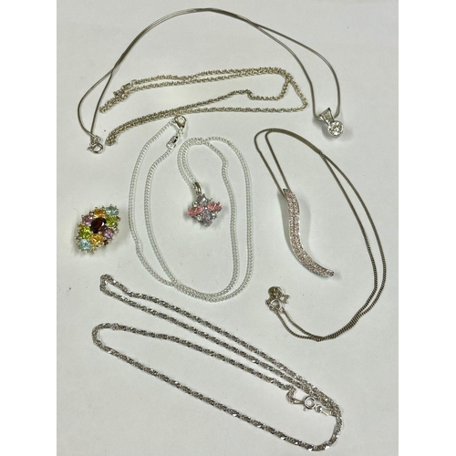 1401 - A collection of silver chains and pendants.