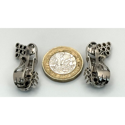 46 - A Gorgeous Art Deco Platinum and Diamond Brooch. Twin scrolled cones with an array of diamond decora... 