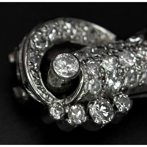 46 - A Gorgeous Art Deco Platinum and Diamond Brooch. Twin scrolled cones with an array of diamond decora... 