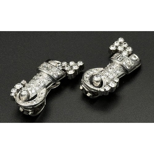 46 - A Gorgeous Art Deco Platinum and Diamond Brooch. Twin scrolled cones with an array of diamond decora... 