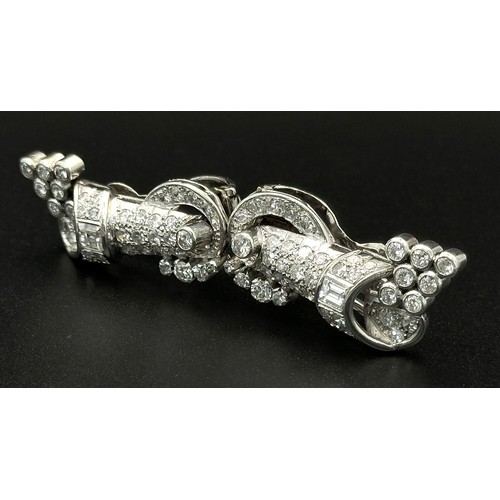 46 - A Gorgeous Art Deco Platinum and Diamond Brooch. Twin scrolled cones with an array of diamond decora... 