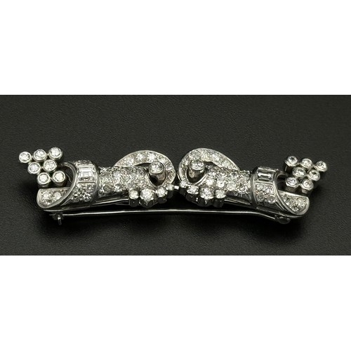 46 - A Gorgeous Art Deco Platinum and Diamond Brooch. Twin scrolled cones with an array of diamond decora... 