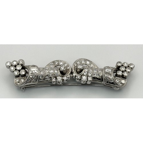 46 - A Gorgeous Art Deco Platinum and Diamond Brooch. Twin scrolled cones with an array of diamond decora... 