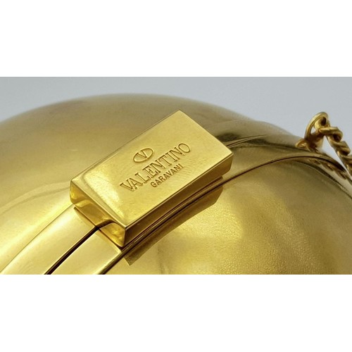 396 - Rare Valentino Gold Orb Clutch Bag. Metal exterior with a stone embellished V logo and clasp fasteni... 