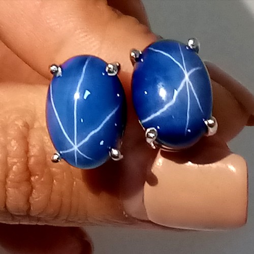 58 - A mesmerising, sterling silver, pair of earrings with a large blue, six ray star sapphire cabochon e... 