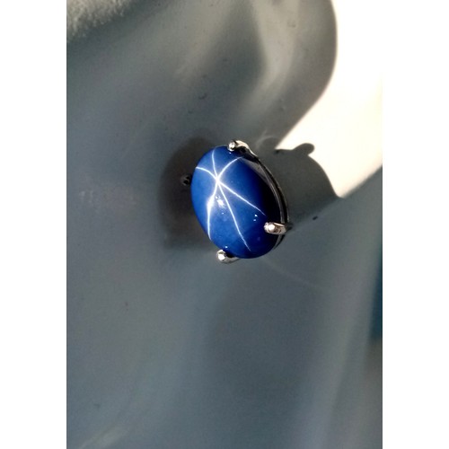 58 - A mesmerising, sterling silver, pair of earrings with a large blue, six ray star sapphire cabochon e... 