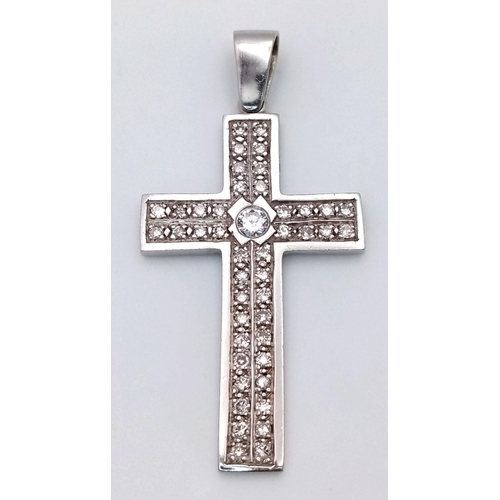 127 - A 9K White Gold Diamond Cross Pendant. 0.5ct central brilliant round cut diamond with a further 36 r... 