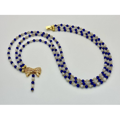 206 - A feminine and sophisticated three row necklace with moonstone and blue sapphires accompanied by a p... 