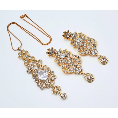 255 - A very regal set of a pair of earrings and matching pendant with chain. Studded with cubic zirconia ... 