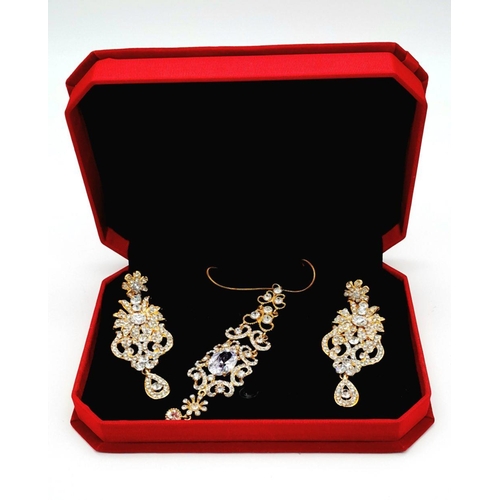 255 - A very regal set of a pair of earrings and matching pendant with chain. Studded with cubic zirconia ... 