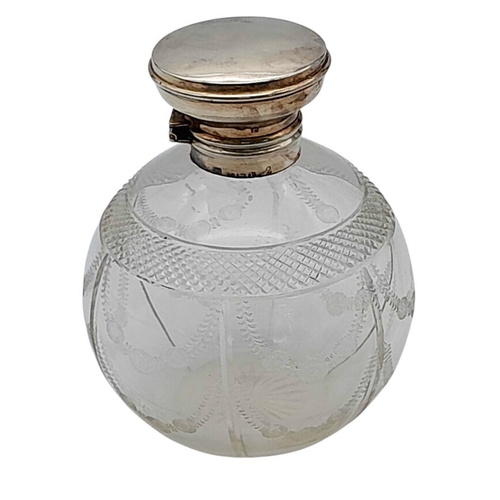 786 - An Antique Silver Top Glass Perfume Bottle. Hinge is broken so as found. Faded hallmarks. 12cm tall.