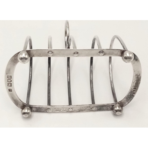 793 - An Antique Sterling Silver Toast Rack. Hallmarks for London 1904. Hukin and Heath makers mark. 10cm.... 