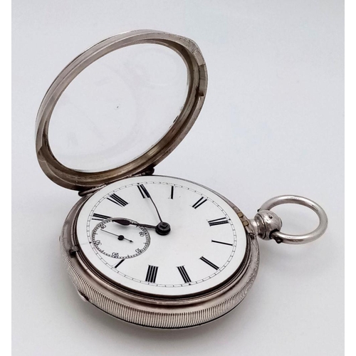 821 - An Antique Sterling Silver Pocket Watch - With Key. Chester hallmarks for 1891. White dial with seco... 