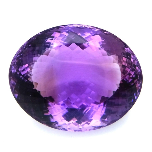 1101 - A 139.65ct natural amethyst gemstone in a rare collector's size, in oval mixed cut. Comes with IGITL... 