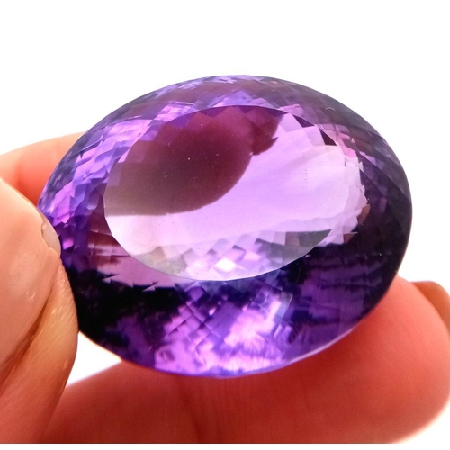 1101 - A 139.65ct natural amethyst gemstone in a rare collector's size, in oval mixed cut. Comes with IGITL... 