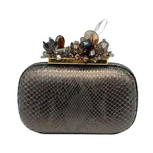 179 - A Madiso Brown Clutch Bag. Python skin exterior with stone embellish clasp fastening closure. Silver... 